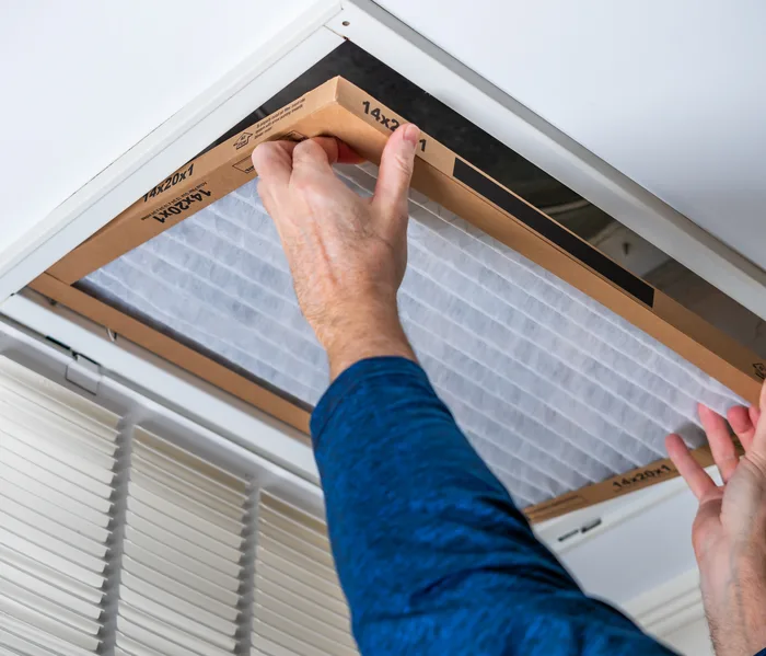 Air filter being replaced at a return air grille
