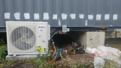 Gree ductless mini-split outdoor condenser mounted against an exterior wall
