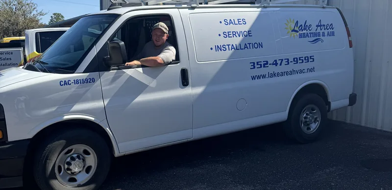Lake Area Heating & Air technician in a branded service van at the shop